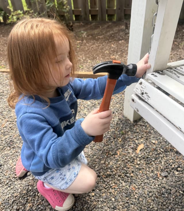  Child using toy hammer