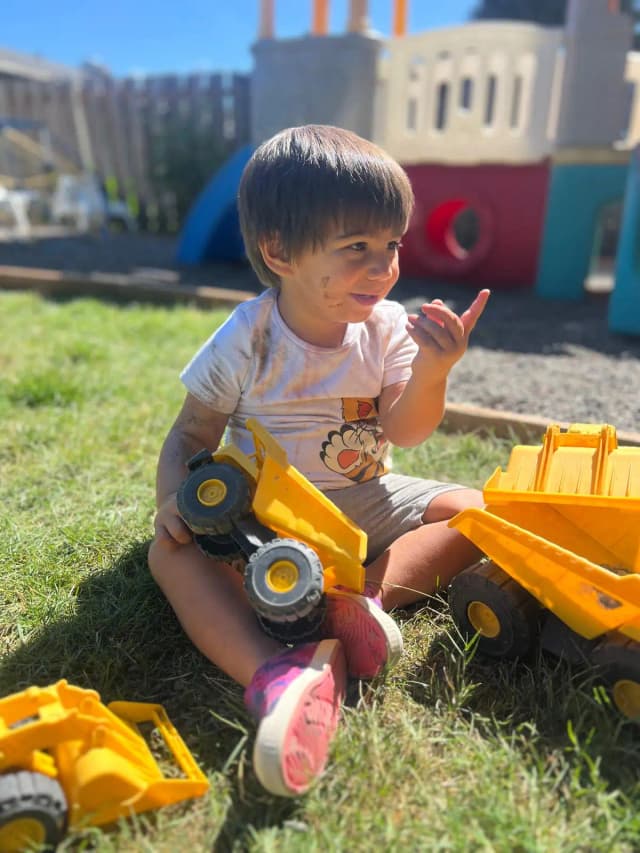  Child with yellow toy truck